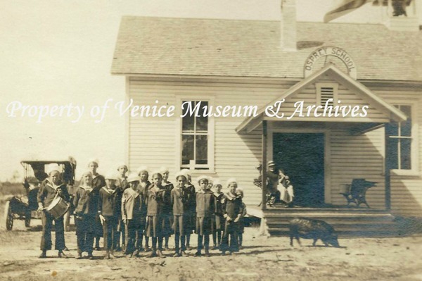 children in nautical school uniforms standing in front of the Osprey School circa 1920